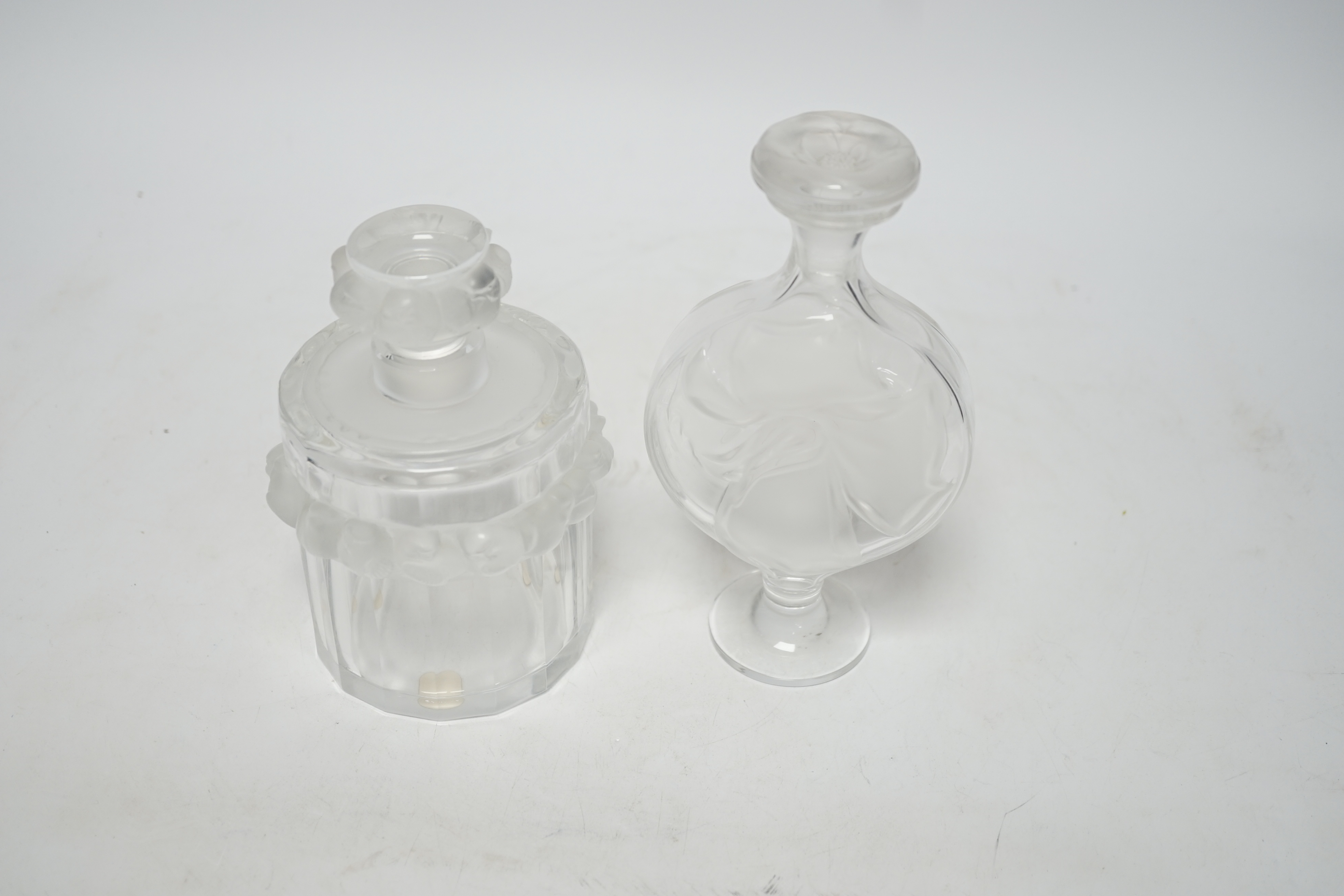 Two Lalique glass scent bottles and stoppers comprising ‘Robinson’ and ‘Moulin Rouge’, signed to the bases, largest 17cm high